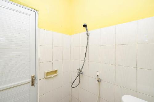 een badkamer met een douche met een slang bij SPOT ON 2821 Griya Kawula Syariah in Solo