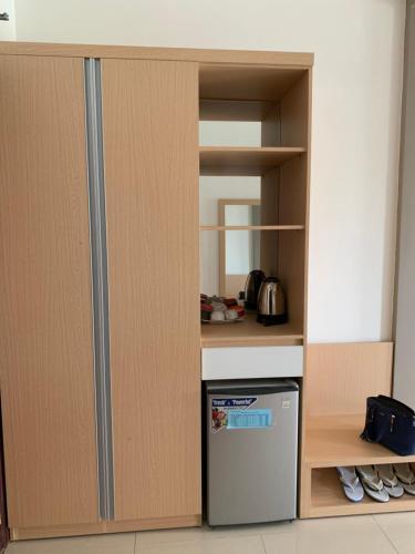 a kitchen with a stove and a refrigerator at Phuc Hung Hotel in Rach Gia