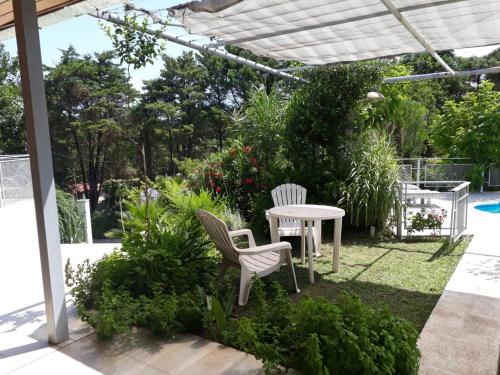 un patio con 2 sillas y una mesa en Casa en Villa Allende Lomas en Villa Allende
