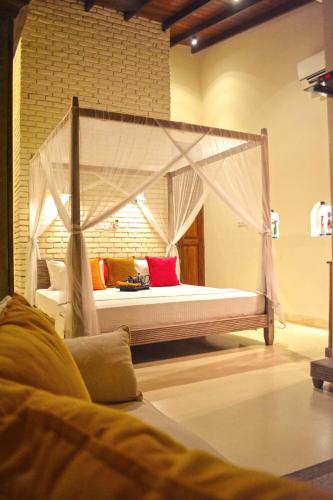 a bed with a canopy in a room at Urban Bliss Studio in Colombo
