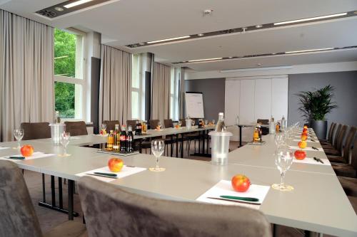 a conference room with long tables and chairs with fruit on them at Hotel Stadtpalais in Cologne