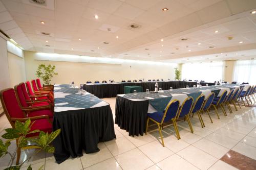 a row of tables and chairs in a room at The Kairaba Beach Hotel in Kololi