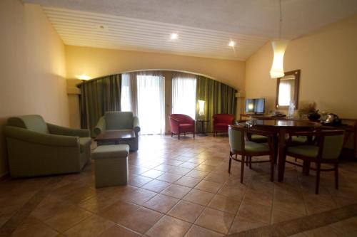 a living room with a table and chairs at The Kairaba Beach Hotel in Kololi
