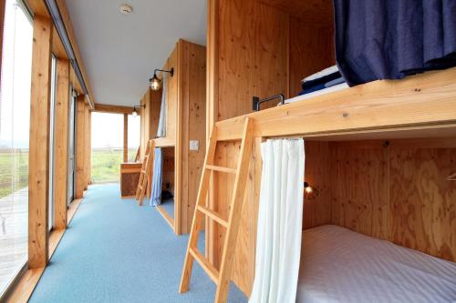 a room with bunk beds in a cabin at COCORETO The Guesthouse Daikon Island in Matsue