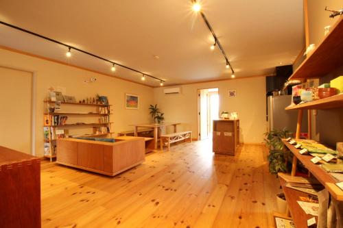 a room with a kitchen with a hard wood floor at COCORETO The Guesthouse Daikon Island in Matsue