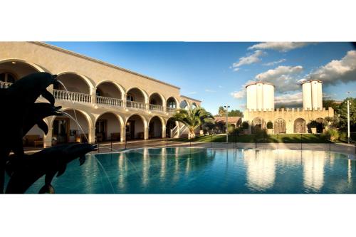 a view of a building with a pool of water at Villaggio San Giovanni in San Giorgio Ionico