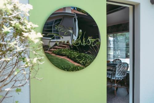 a round mirror on a wall next to a door at Timeless Bloemfontein in Bloemfontein