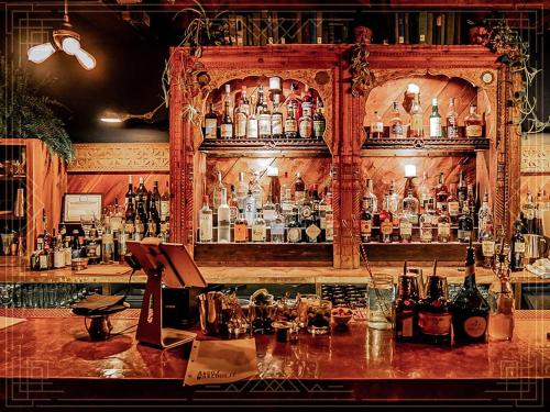 a bar with a lot of bottles of alcohol at Argos Inn - Ithaca's Boutique Hotel in Ithaca