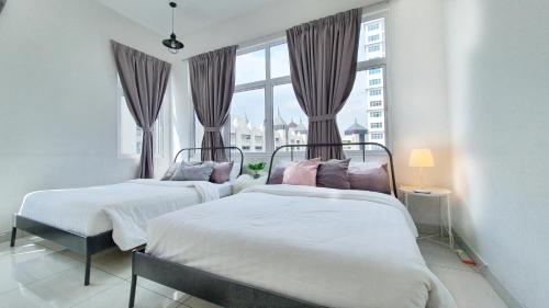 two beds in a bedroom with a window at No.7 The Zebra @ Puchong Skypod Residence in Puchong