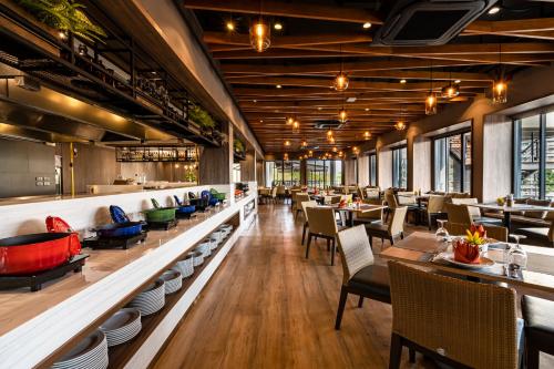 a dining room with tables and chairs and tablesktop at G Hua Hin Resort & Mall in Hua Hin