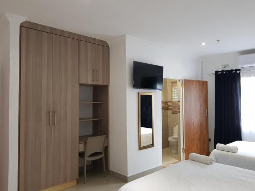 Ένα ή περισσότερα κρεβάτια σε δωμάτιο στο Ushaka Bed and Breakfast Richards Bay