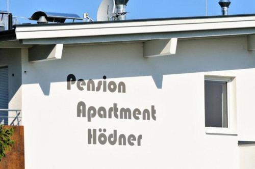 a sign on the side of a building at Pension Apartment Hödner in Ebbs