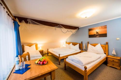 a room with two beds and a table with a bowl of fruit at La Port in Znojmo