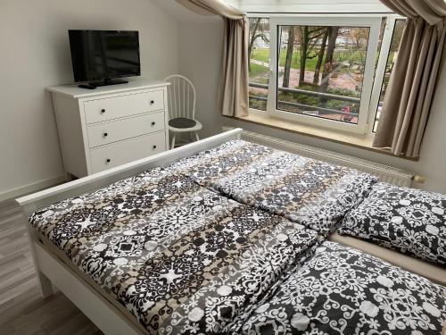 Ένα ή περισσότερα κρεβάτια σε δωμάτιο στο Ferienwohnung " Haus am Meer "