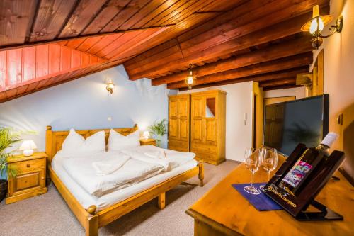 a bedroom with a bed and a desk with a tv at La Port in Znojmo
