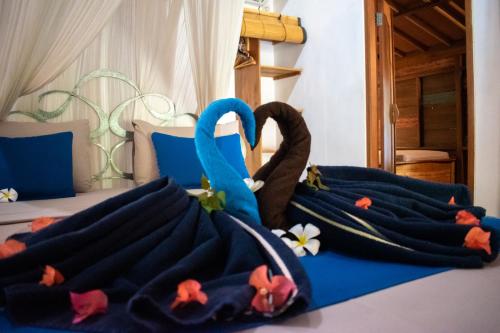 a group of towels on a bed at Jati Village, Party Hostel and Bungalows in Gili Trawangan