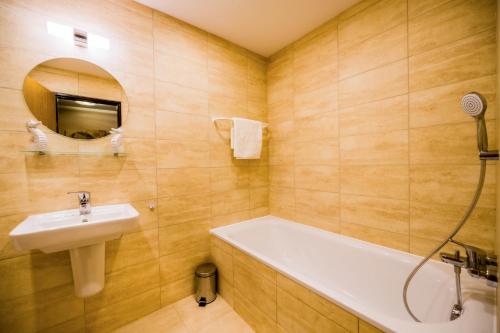 a bathroom with a bath tub and a sink at La Port in Znojmo