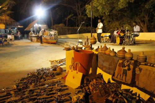 a group of pots and vases on a table at night at The Kairaba Beach Hotel in Kololi