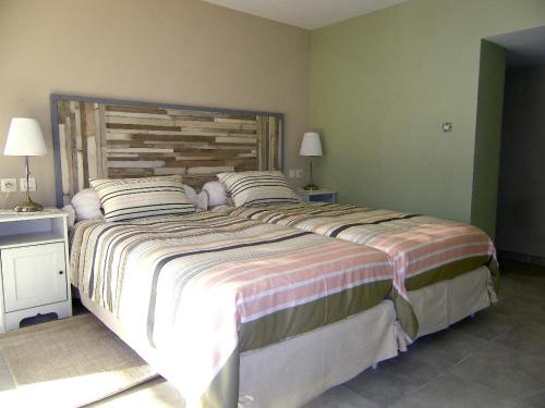 a bedroom with a large bed with a wooden headboard at Villamijo in Le Beausset