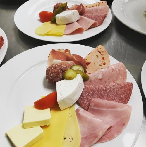 two plates of different types of cheese and meats at Auersberg Haus in Eibenstock