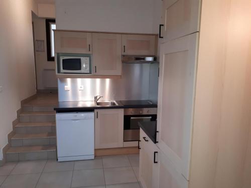 a kitchen with a sink and a microwave at VVF Résidence Anglet in Anglet