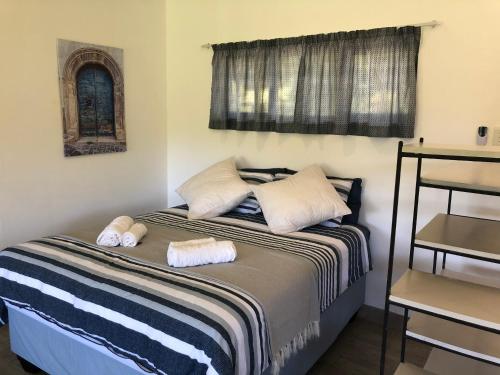 a bedroom with a bed with two towels on it at Secret Sithela in Port Edward