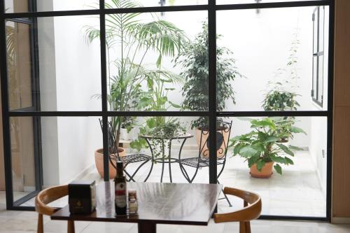 a table and chairs in a room with potted plants at Hotel Casbah in El Puig