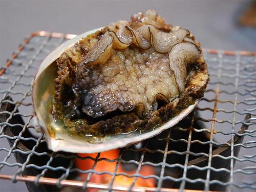 a crab sitting on top of a grill at Suzunami in Toba