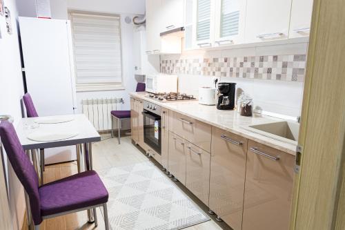 eine Küche mit Spüle und Herd oberen Backofen in der Unterkunft Unique Hotel Apartments Grand Residence in Iaşi