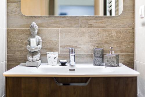 ein Waschbecken mit einer Statue darüber in der Unterkunft Unique Hotel Apartments Grand Residence in Iaşi