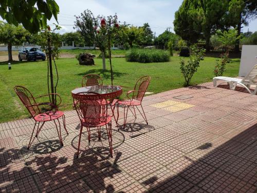 a group of chairs and a table in a patio at Lucid Dream Apt. |Bozinis in Psakoudia