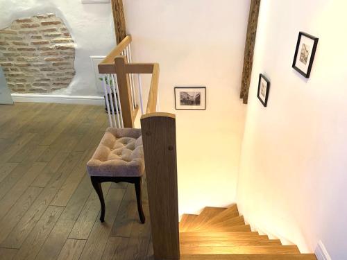 a staircase with a chair next to a stair case at Very Vilnius Pilies street in Vilnius