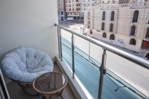 a balcony with a blue bean bag chair and a view at Redcon Suites in Hurghada