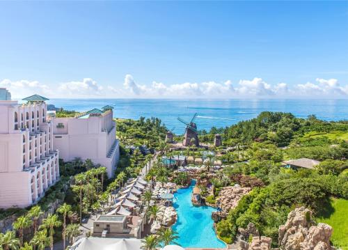 an aerial view of the resort with the ocean in the background at Lotte Hotel Jeju in Seogwipo