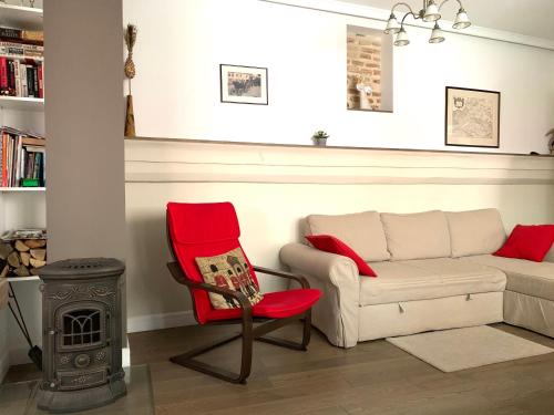 a living room with a couch and a chair and a stove at Very Vilnius Pilies street in Vilnius