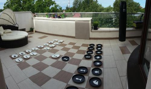 a chess board on top of a patio with a chessboard at MadamPuzo Terrace in Rīga