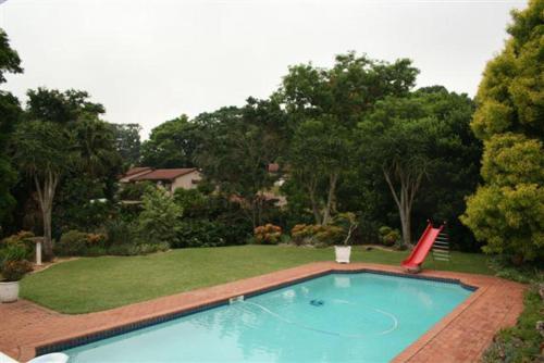 a large swimming pool in a yard with a lawn sidx sidx sidx at Firenze in Kloof