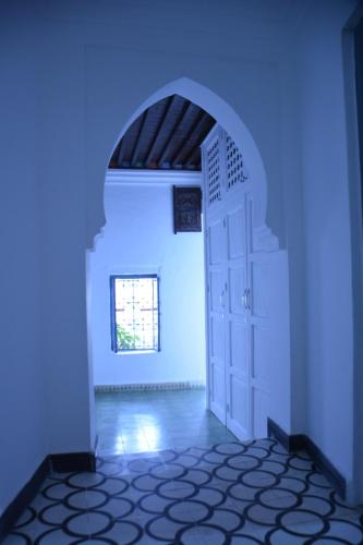 a blue room with a door and a window at Casa Perleta in Chefchaouene