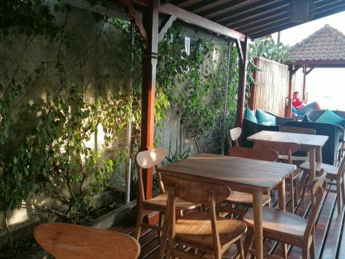 a wooden table and chairs on a patio at Puri Oka Beach Bungalows in Candidasa