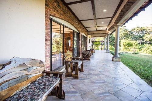 a porch with benches on the side of a building at Stephan's Guest House in Port Shepstone