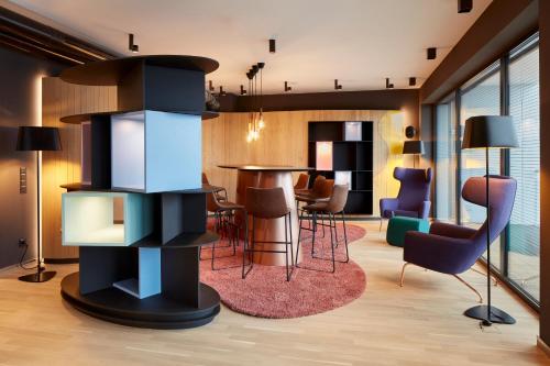 a living room with a table and chairs at Hotel im LESKANPark in Cologne
