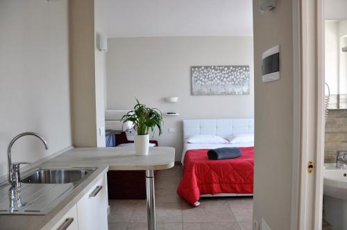 a kitchen with a sink and a bed in a room at Agriturismo & Agricamping Serena in Pastrengo