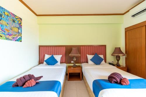 En eller flere senge i et værelse på Thipurai Beach Hotel