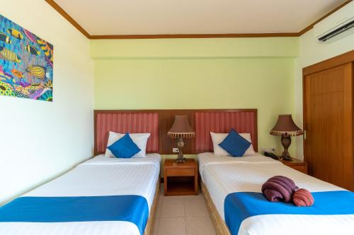 En eller flere senge i et værelse på Thipurai Beach Hotel