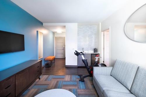 a living room with a couch and a flat screen tv at EVEN Hotel Miami - Airport by IHG in Miami