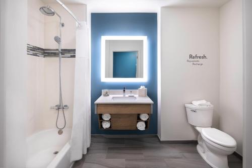 a bathroom with a white toilet and a sink at EVEN Hotel Miami - Airport by IHG in Miami