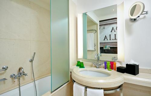 a bathroom with a sink and a mirror at Hotel Indigo Rome - St. George by IHG in Rome