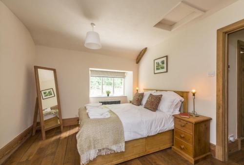 En eller flere senger på et rom på Horsehill Cottage