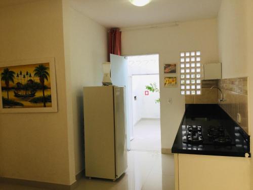 a kitchen with a refrigerator and a stove at Villa Vanuza in Santa Cruz Cabrália