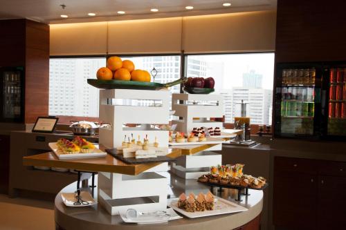 a buffet line with food on display in a restaurant at Holiday Inn & Suites Makati by IHG in Manila